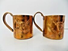 A Pair Of Copper Bull Dozer Collectible Mugs With A Bull Dozer Drink Recipe